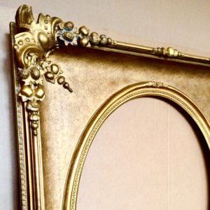 Replacement cast ornament is fit on to frame, gilded and the finish is blended.